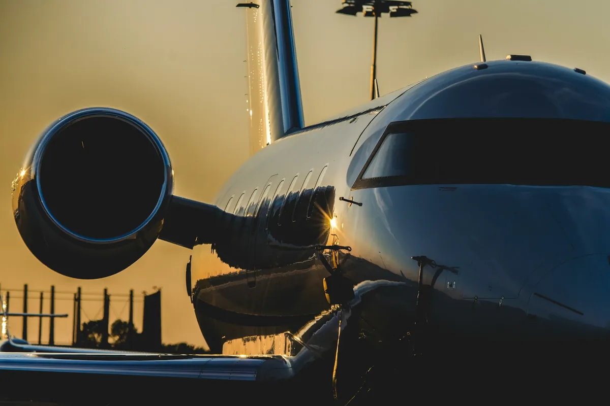 Nose of a large-cabin business jet at golden hour
